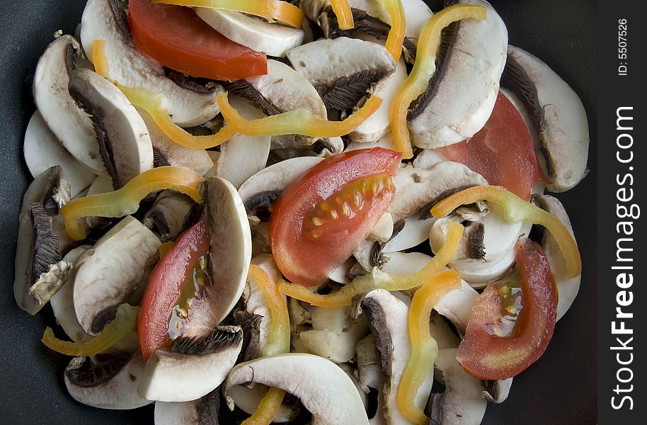 Cut mushrooms with fresh vegetables ready to be cooked. Cut mushrooms with fresh vegetables ready to be cooked