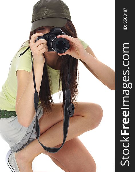 Young beautiful woman holding a photo camera. Isolated over white background. Young beautiful woman holding a photo camera. Isolated over white background