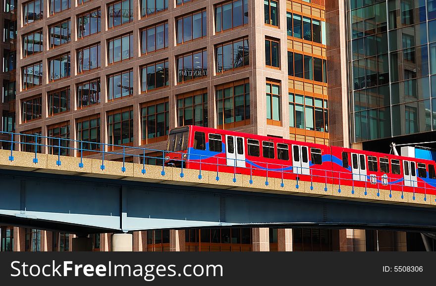 Red Train Crossing A Bridge