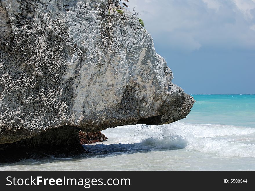 The rock that was shaped by the sea on Tulum beach, Mexico. The rock that was shaped by the sea on Tulum beach, Mexico.
