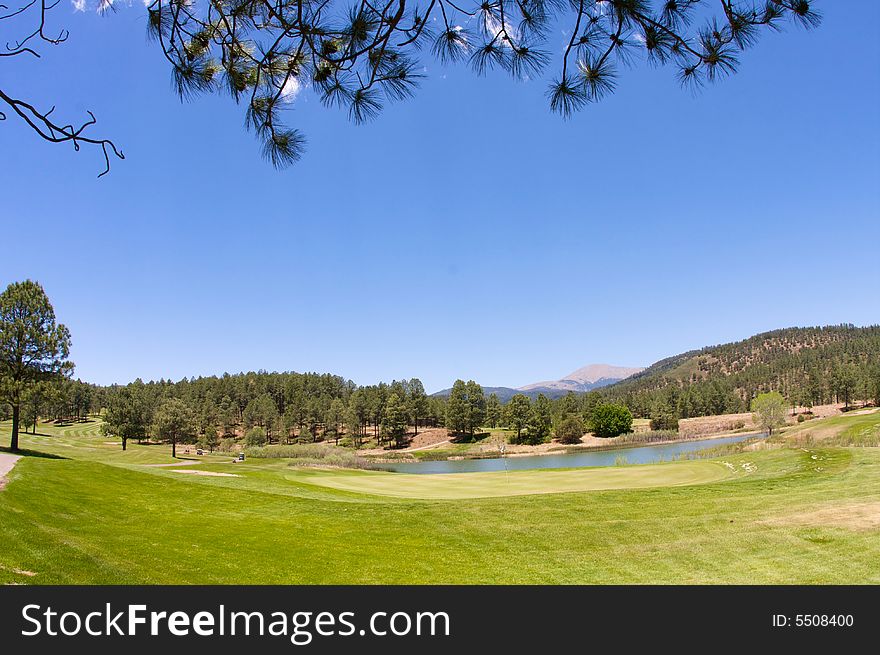 An image of a Arizona golf course with lush vegetation and mountain peaks. An image of a Arizona golf course with lush vegetation and mountain peaks