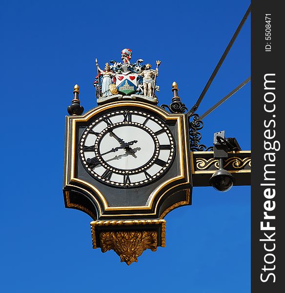 Wall ancient clock with a clear blue background. Wall ancient clock with a clear blue background