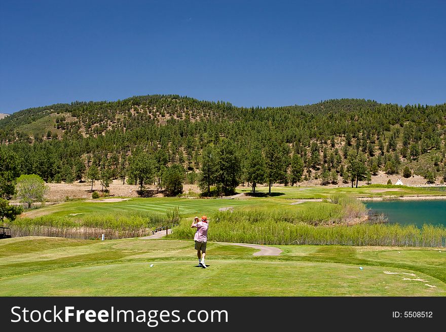 An image of a golfer following through on a swing. An image of a golfer following through on a swing