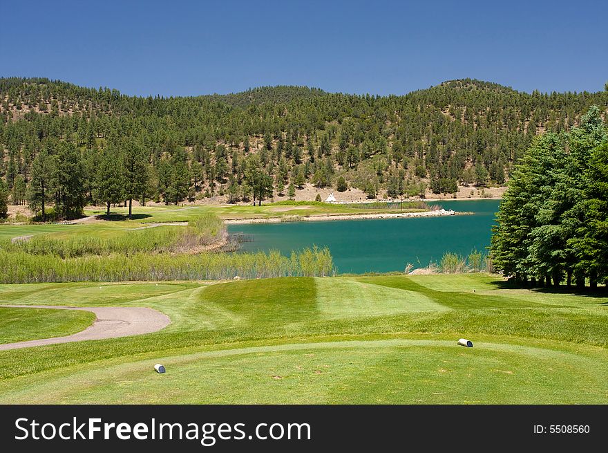 An image of a aqua lake set near a golf hole. An image of a aqua lake set near a golf hole