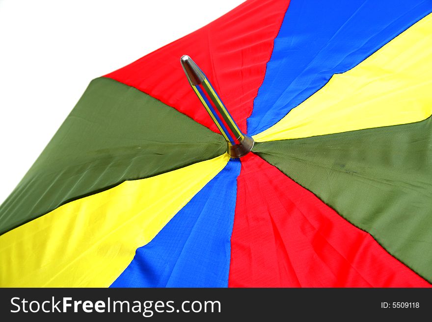 Detail of the top of a colorful umbrella on white