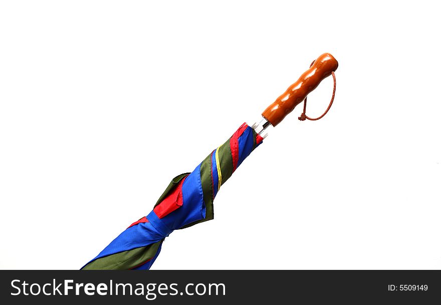 Detail of a folded colorful umbrella isolated on white