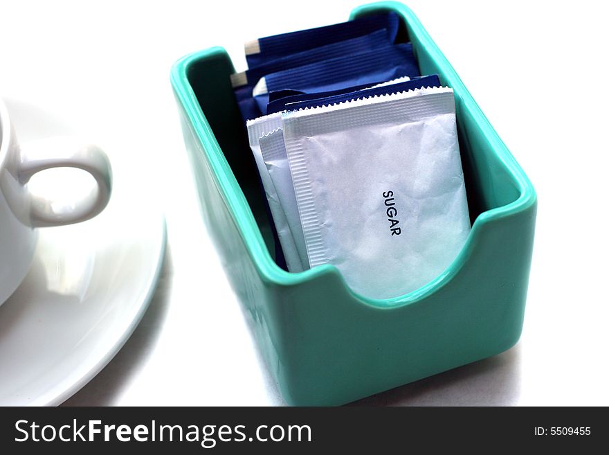 Sugar sachet in bowl with copy cup near by