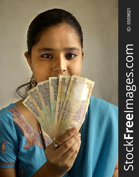 A woman holding Indian currency. A woman holding Indian currency.