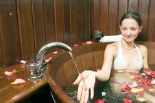 Woman By A Faucet In Tub - Horizontal Royalty Free Stock Photos