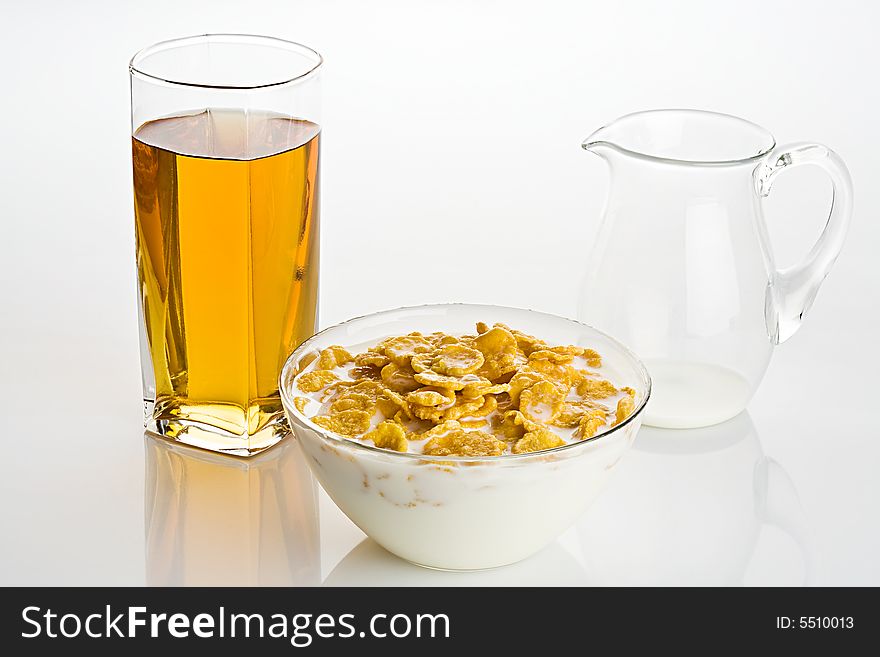 Big glass of apple juice and  corn-flakes with milk. Big glass of apple juice and  corn-flakes with milk