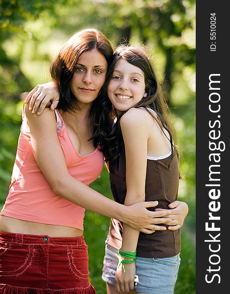 Two young girls - teenagers,  on a green background. Two young girls - teenagers,  on a green background