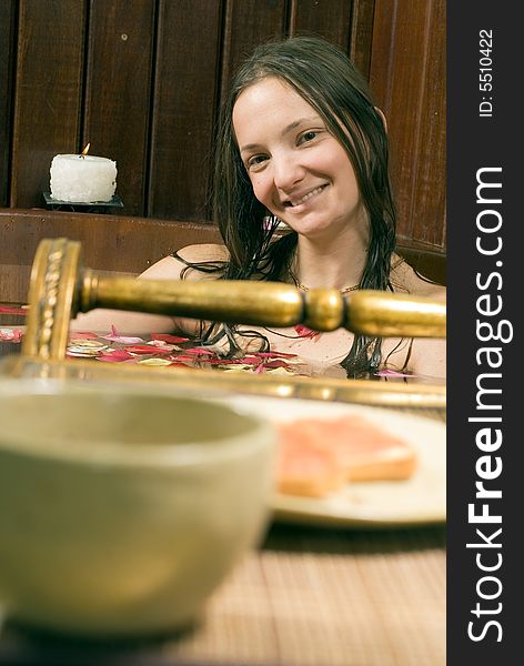 Woman Smiles and Relaxes in Tub - Vertical