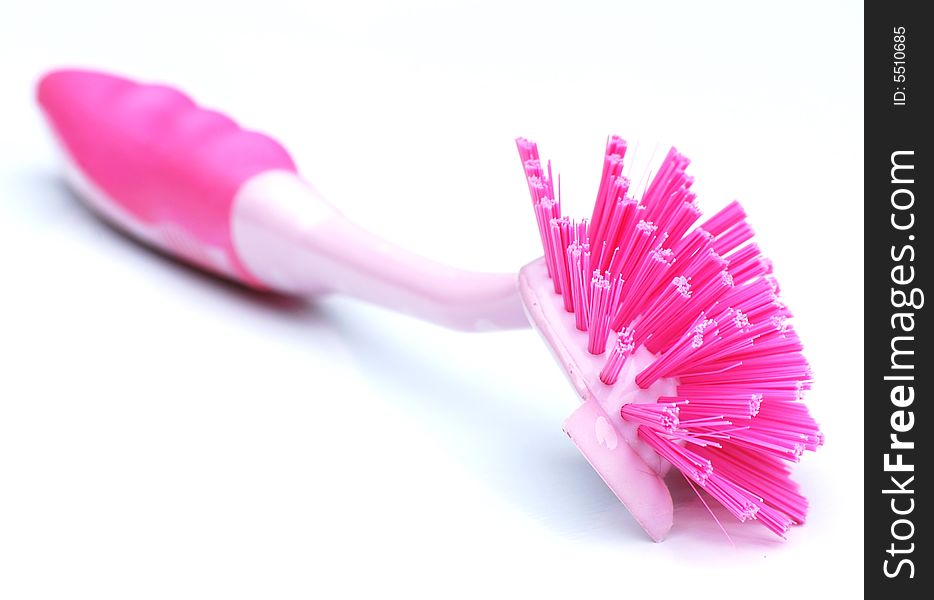 A pink kitchen brush isolated on white