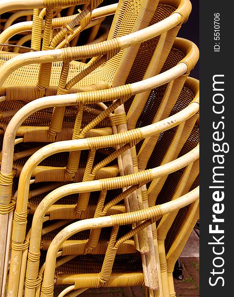 Stored stackable chairs waiting for customers at a terrace