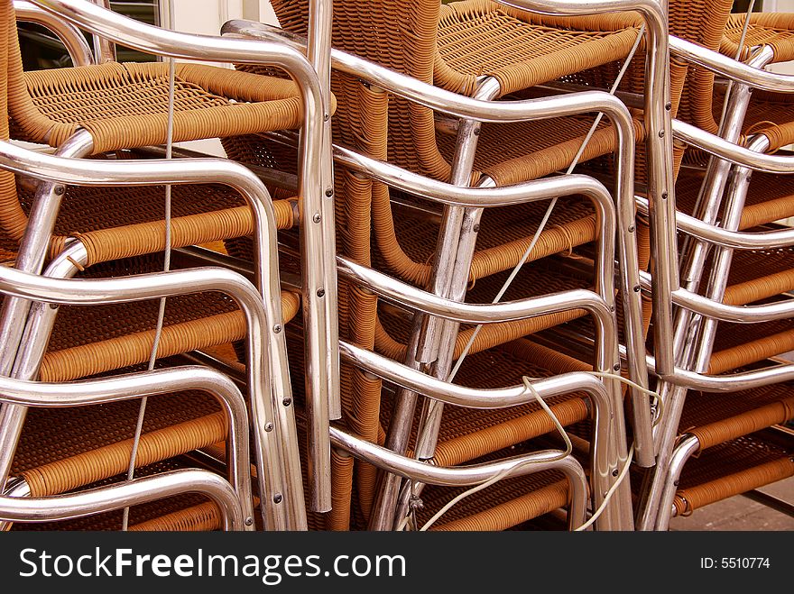 Stored stackable chairs waiting for customers at a terrace