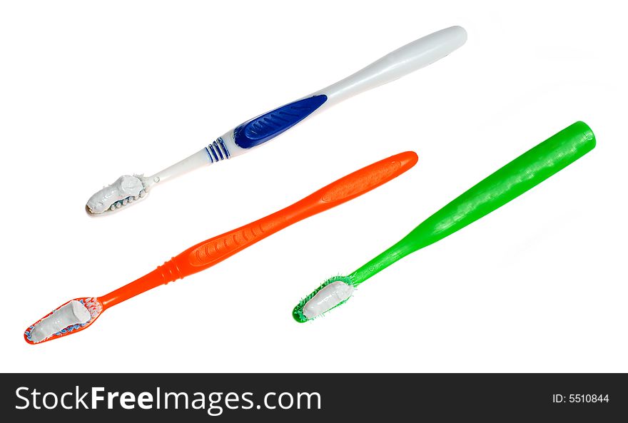 Threee toothbrushes with toothpaste on its isolated on white
