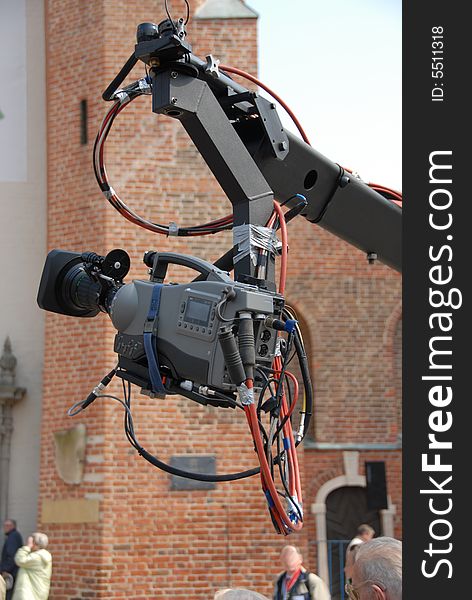 A fancy video camera high-up on a boom arm. A fancy video camera high-up on a boom arm