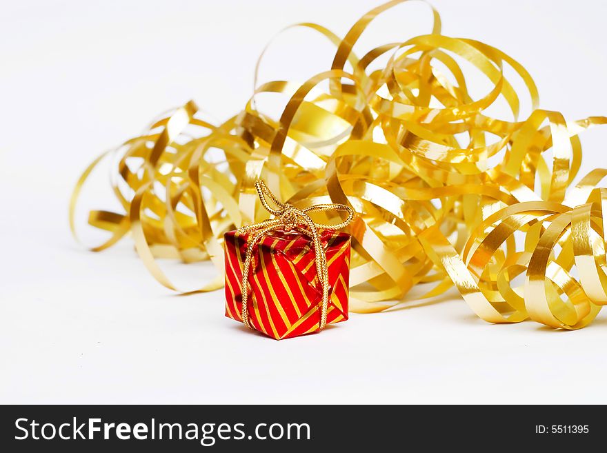 Christmas decoration - golden  ribbon and small red present