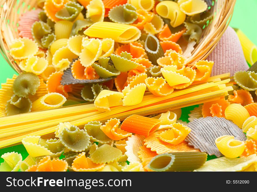 Assorted colorful uncooked pasta as background