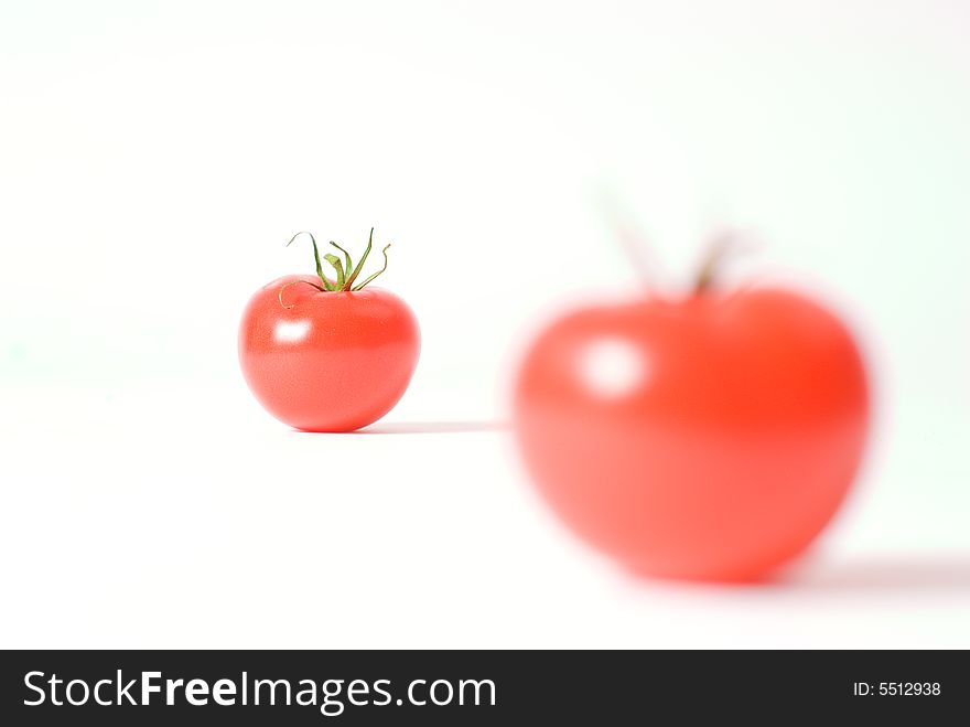 Two red tomatos studio isolated.