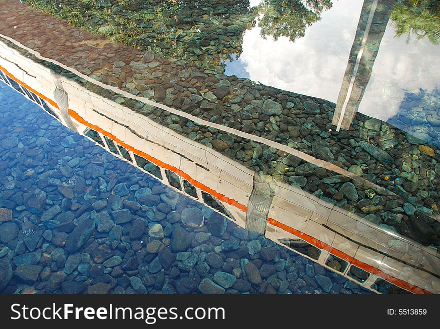 A monorail reflected in clear water. A monorail reflected in clear water