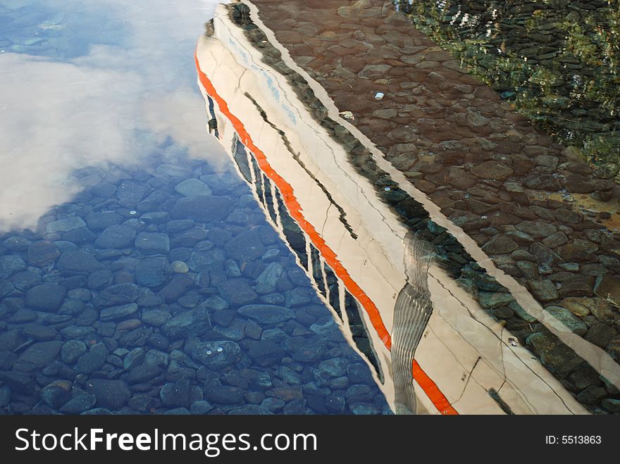 A monorail reflected in clear water. A monorail reflected in clear water