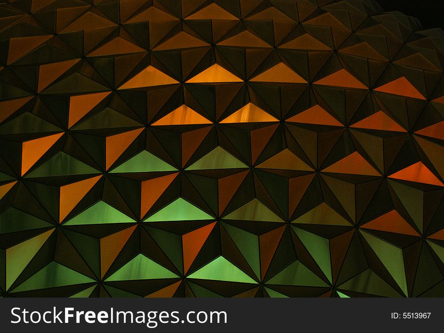 A metallic pattern illuminated in green and red