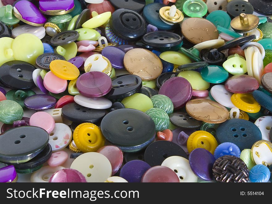 Heap of buttons of different colors round from plastic