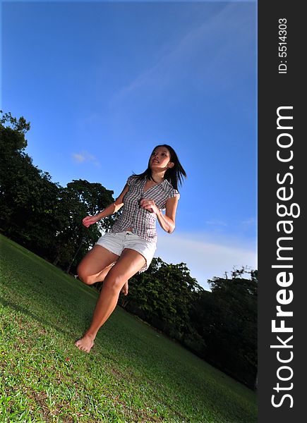 Picture of a Happy Girl out in the park. Indicative of mood, joyous occasion, promotion of healthy living and lifestyle. Picture of a Happy Girl out in the park. Indicative of mood, joyous occasion, promotion of healthy living and lifestyle.