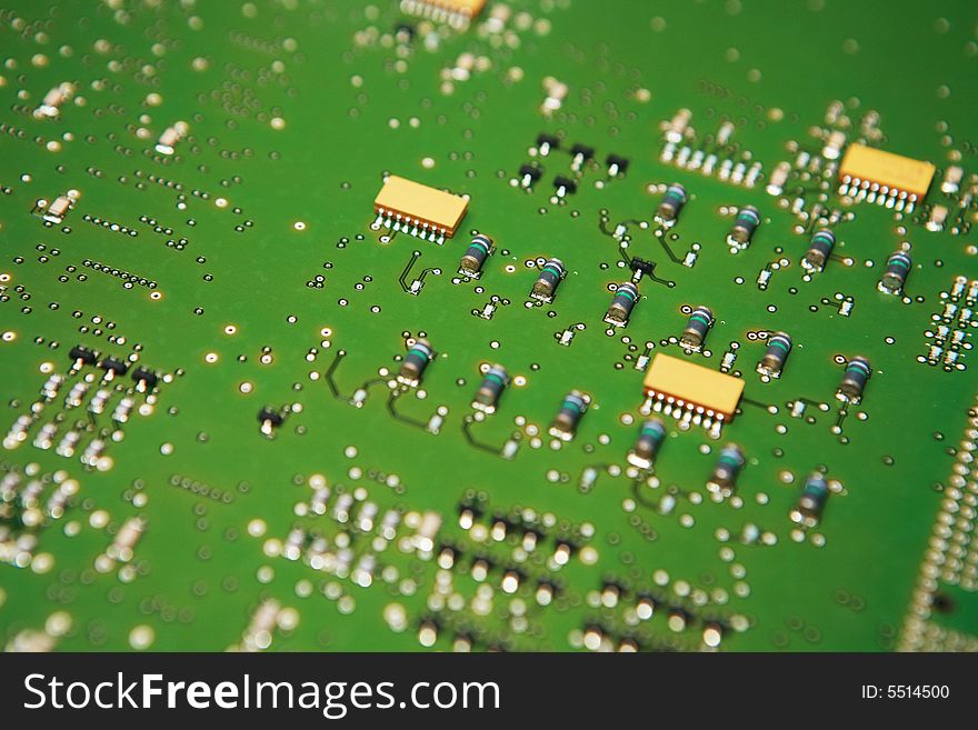 Closeup view of the component side of a circuit board. Capacitors,IC's,solder joints and traces showing. Closeup view of the component side of a circuit board. Capacitors,IC's,solder joints and traces showing.