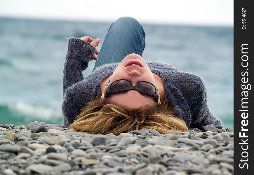 Young lady on Beach Resting in Sunglasses