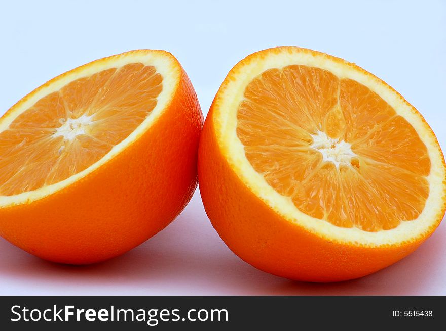 Two halves of orange isolated on the white background