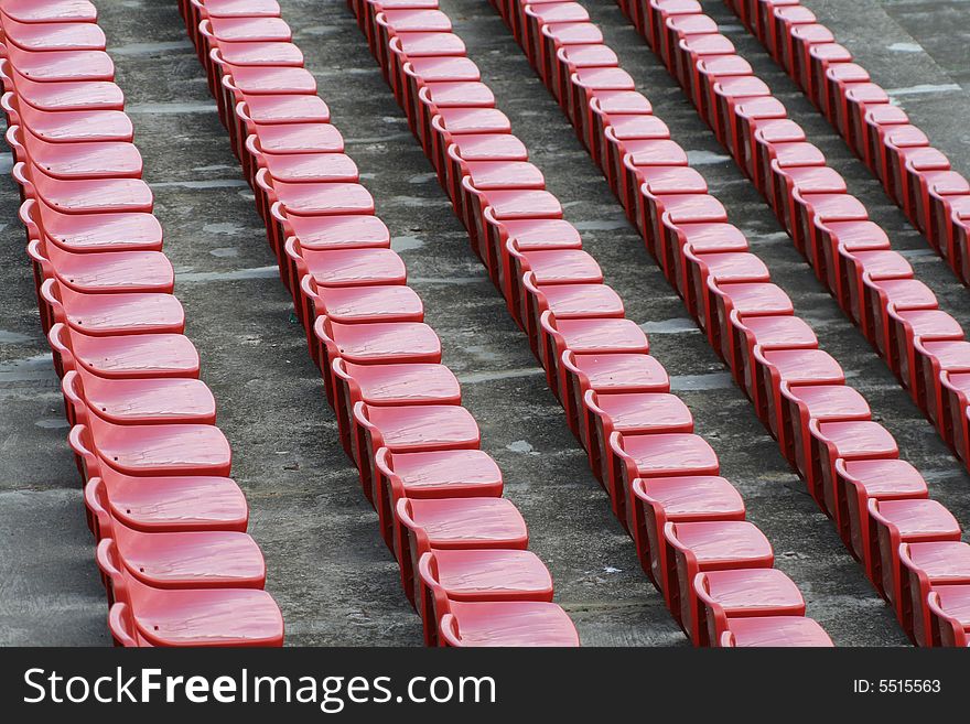 Empty red chairs in open-air arena