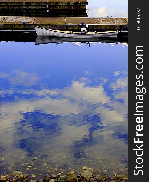 Small boat tied up at empty wooden docks. Small boat tied up at empty wooden docks