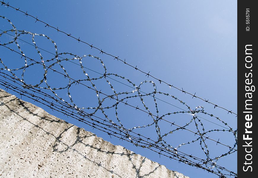 Barbed wire on a background blue sky