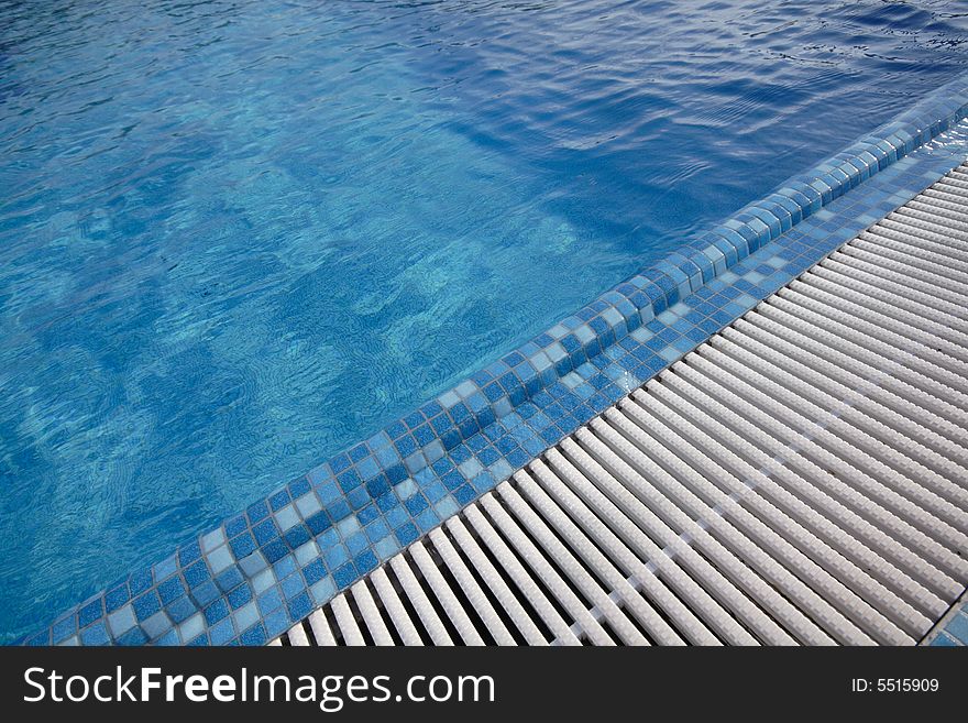 Swimming pool blue water in a summer day