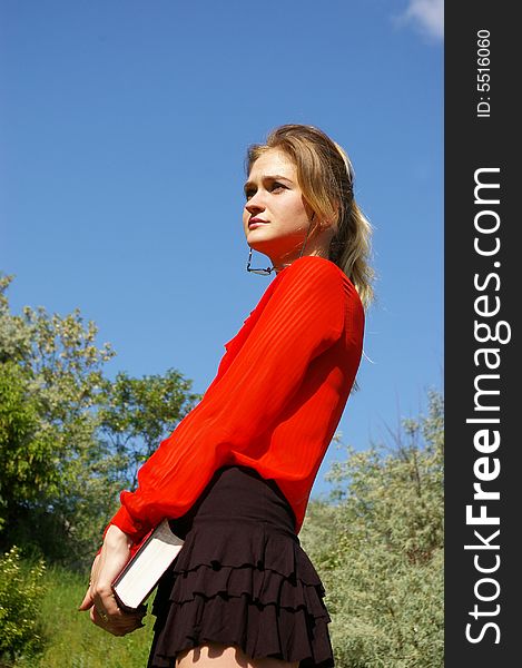 Cute woman in red holding a book