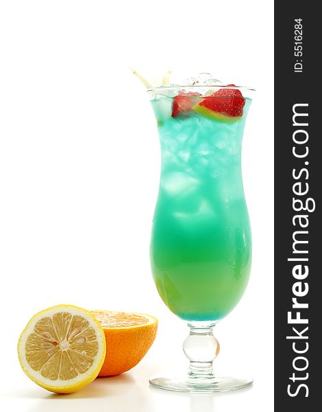 Tropical Acoholic Drink Made of Rum, Pineapple Juice, Blue Curacao, Sweet and Sour Mix. Slice of Apple and Strawberry as a Garnish. Tropical Acoholic Drink Made of Rum, Pineapple Juice, Blue Curacao, Sweet and Sour Mix. Slice of Apple and Strawberry as a Garnish.