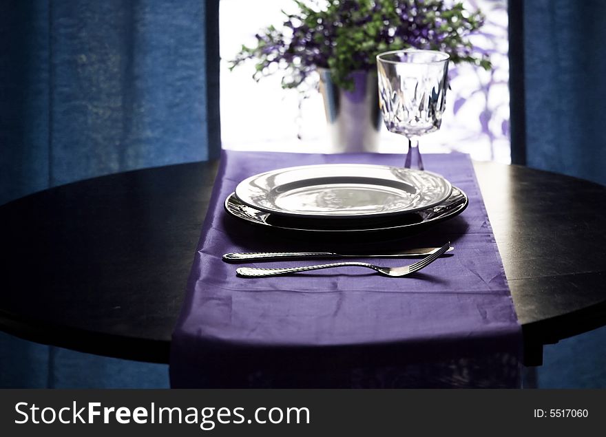 A fancy restaurant table setting in blue. A fancy restaurant table setting in blue