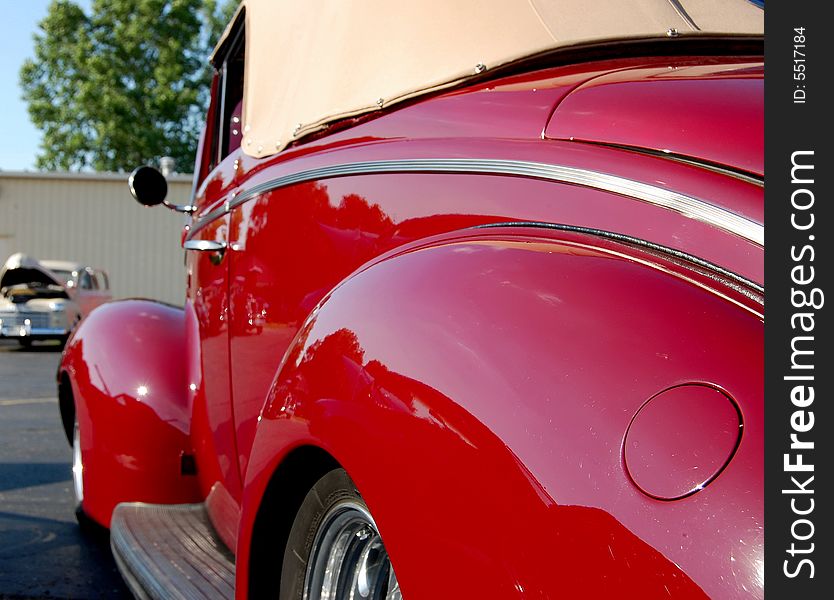 This is the side view of a classic car, fuel door is included in view.