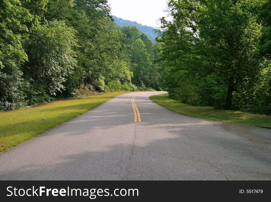 A road winding through the foothills of the Smoky Mountains. A road winding through the foothills of the Smoky Mountains.