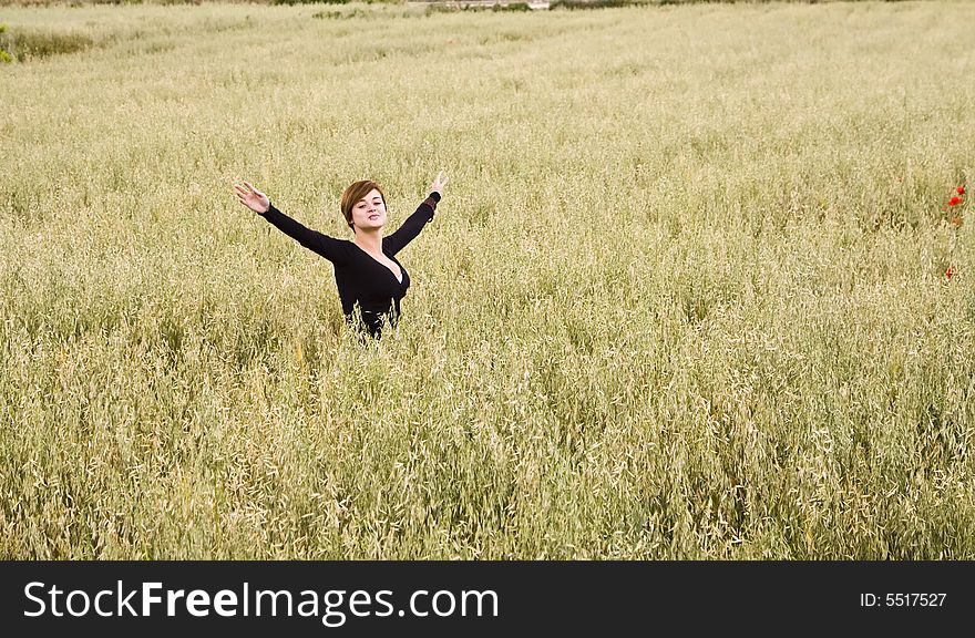 Woman feeling freedom in a field. Woman feeling freedom in a field.