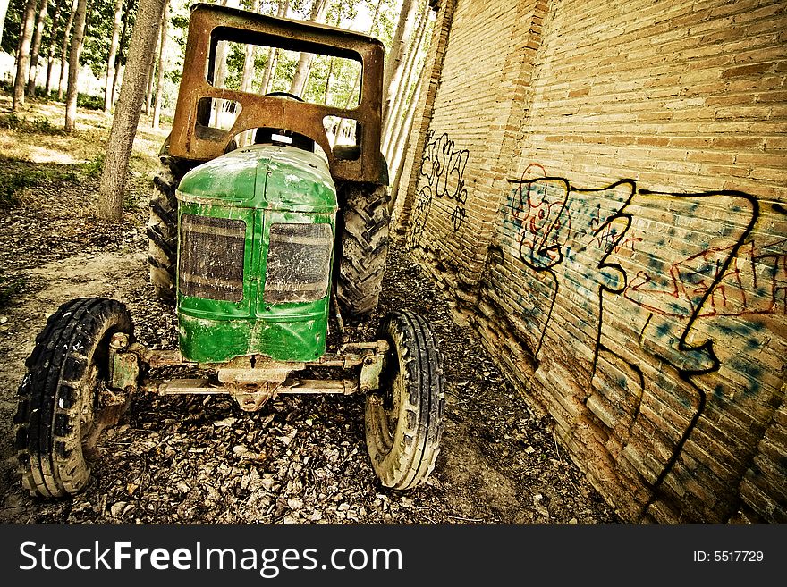 Abandoned tractor close to an old building. Abandoned tractor close to an old building.