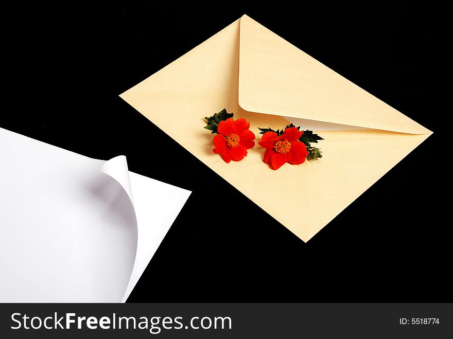 Envelope with blue flowers on black background with pen. Envelope with blue flowers on black background with pen