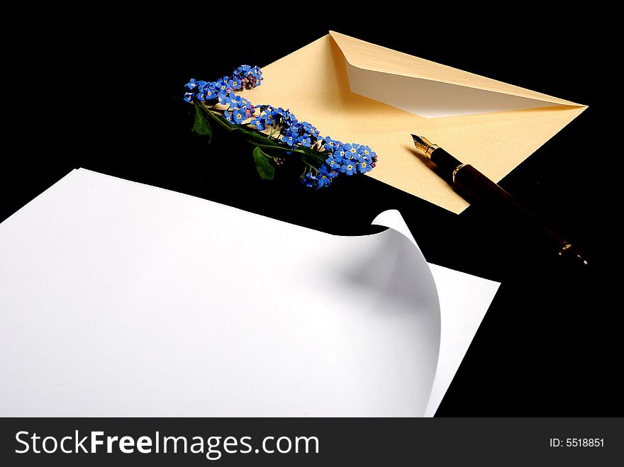 Envelope with flowers and pen