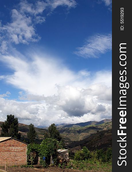 A cloudscape forms over a small house in rural Ecuador. A cloudscape forms over a small house in rural Ecuador