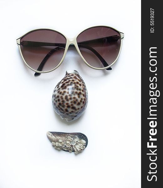 Face. solar glasses and seashells