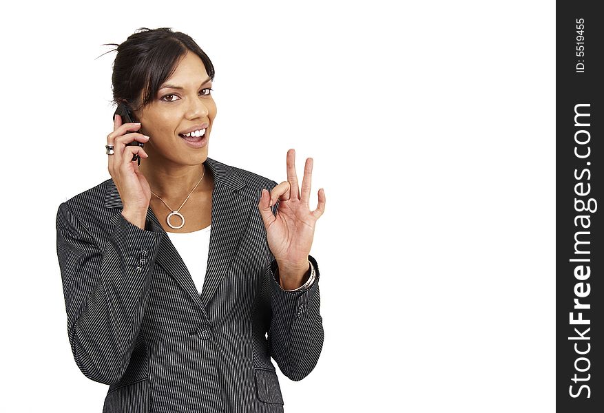 Beautiful brunette woman in pinstripe suit talking on her cellphone. Isolated on white background with copy space