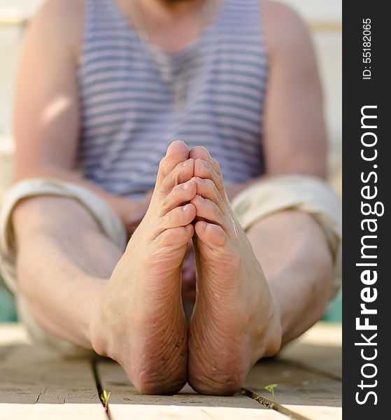 Male feet on a wooden terrace