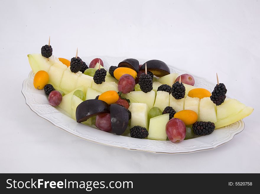 Fruits in the plate, on the white background